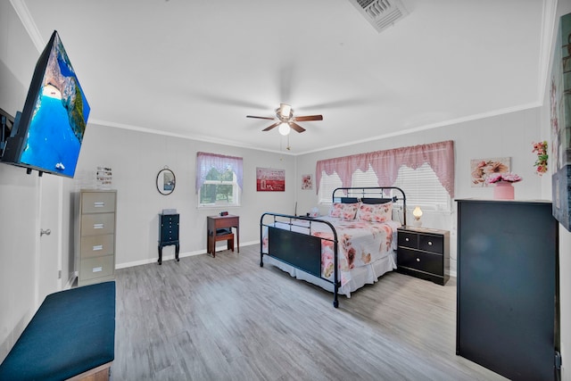 bedroom featuring crown molding, wood-type flooring, and ceiling fan