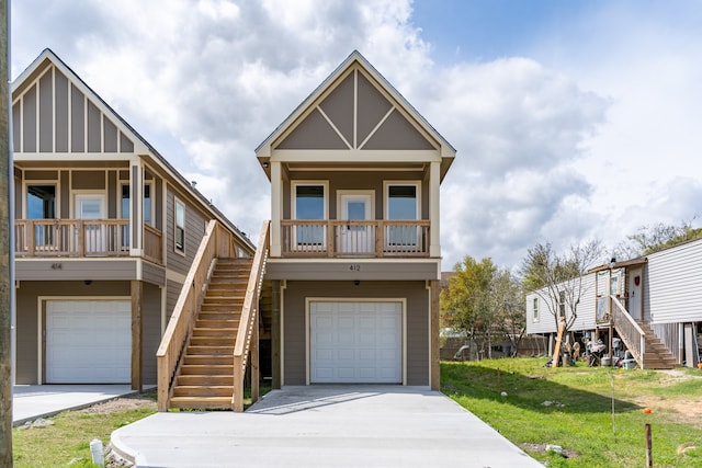 view of front of property featuring a front lawn, covered porch, and a garage