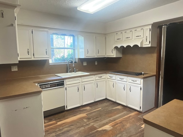 kitchen with white cabinets, white dishwasher, sink, dark wood-type flooring, and electric cooktop