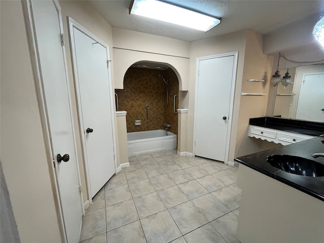 bathroom with bathing tub / shower combination, tile patterned flooring, vanity, and a textured ceiling