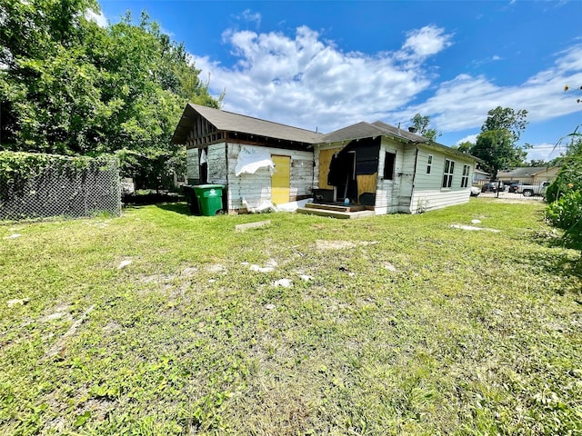 view of side of home featuring a yard