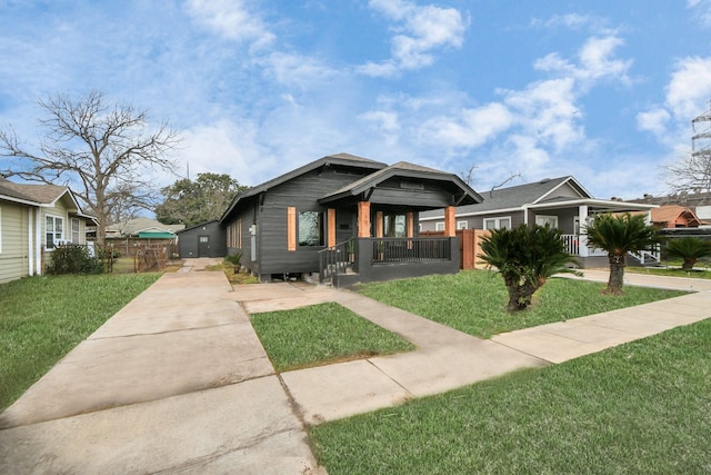 bungalow with a front lawn and covered porch