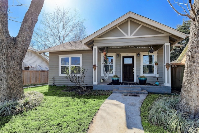 bungalow-style home featuring a front yard