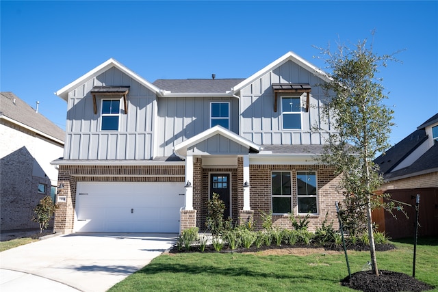 view of front of property with a front yard and a garage