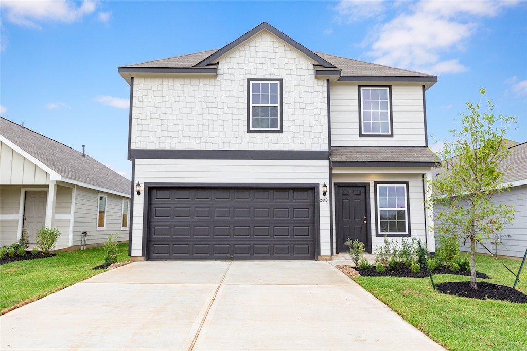 front facade with a garage and a front yard