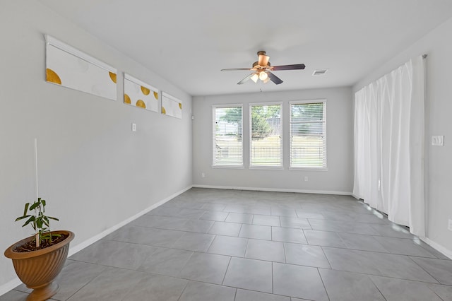 spare room featuring ceiling fan and light tile patterned flooring