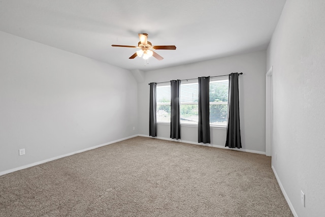 empty room with ceiling fan and carpet flooring