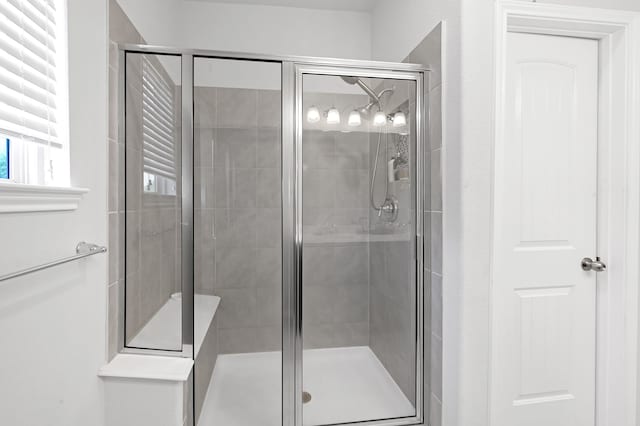 bathroom with a shower with shower door