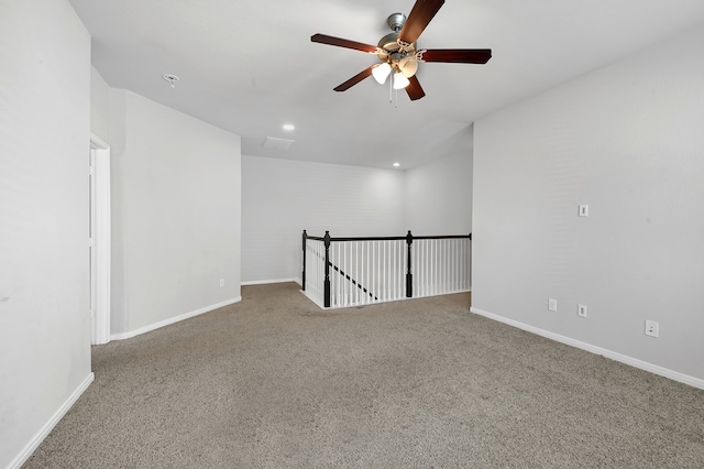 carpeted spare room with ceiling fan