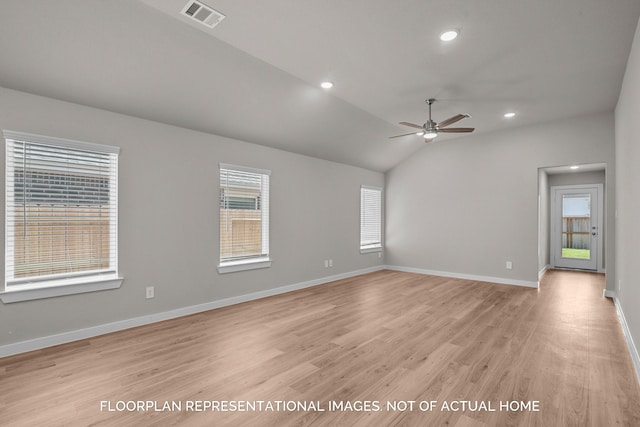 empty room with ceiling fan, light wood-type flooring, and vaulted ceiling