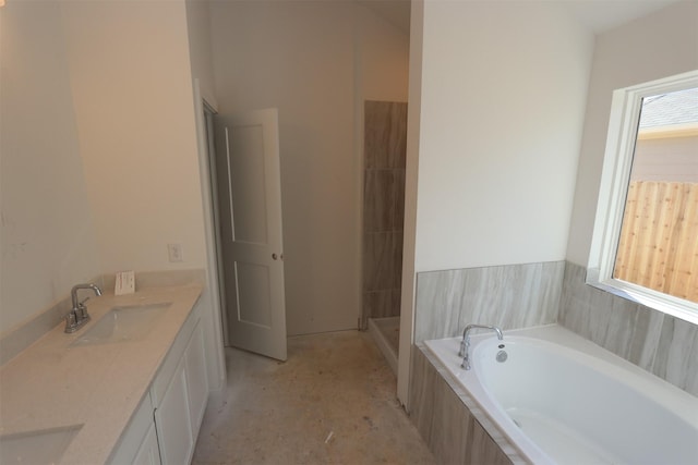 bathroom featuring vanity, plenty of natural light, and independent shower and bath