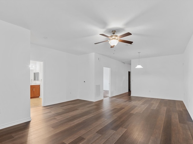 spare room featuring ceiling fan and dark hardwood / wood-style floors