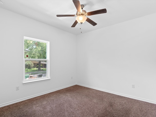 carpeted spare room featuring ceiling fan