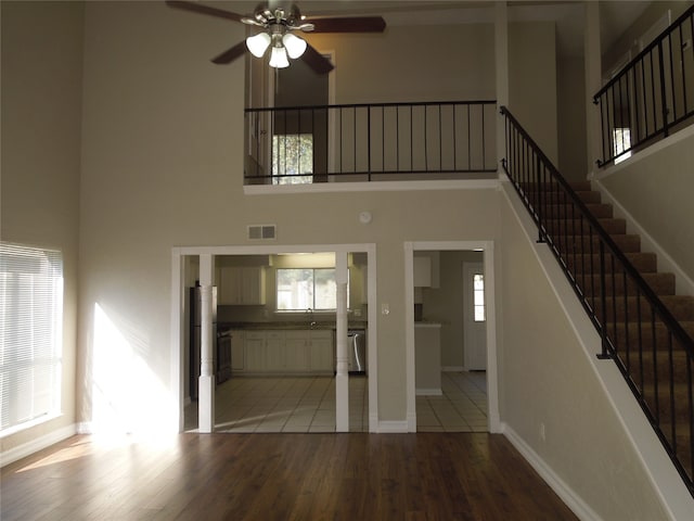 foyer featuring light hardwood / wood-style flooring, a high ceiling, and a healthy amount of sunlight