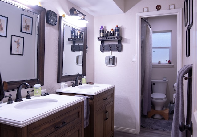 bathroom with walk in shower, vanity, toilet, and hardwood / wood-style flooring