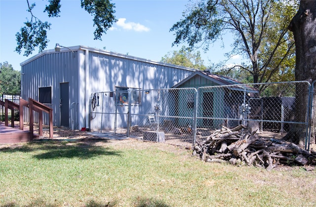 rear view of house featuring a yard and a deck