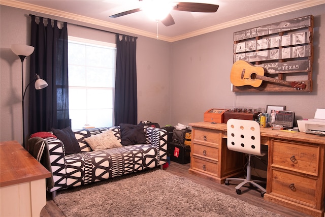 home office featuring ceiling fan, hardwood / wood-style flooring, and crown molding