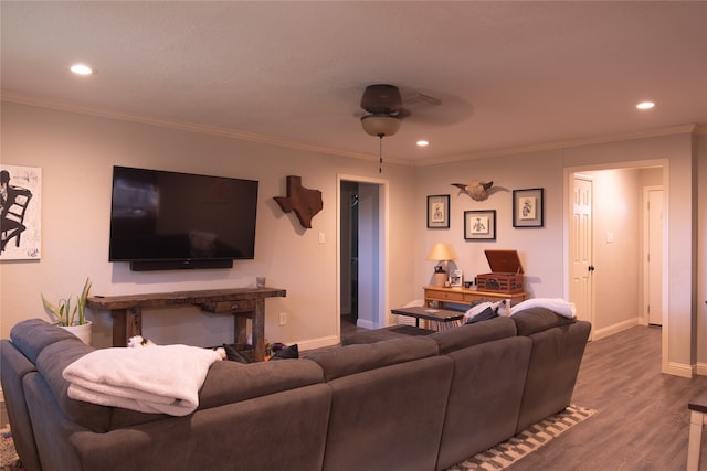 living room with wood-type flooring, ornamental molding, and ceiling fan