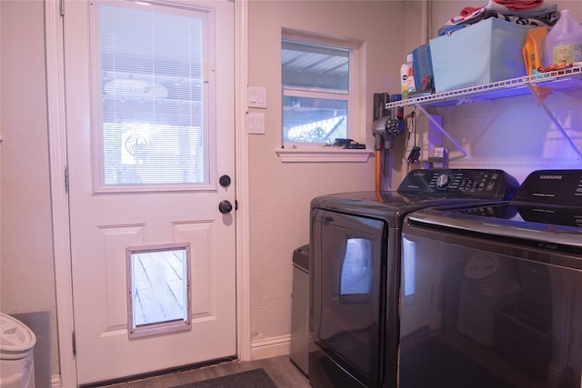 washroom featuring washer and dryer and a healthy amount of sunlight