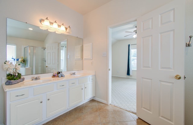 bathroom with tile patterned floors, vanity, a shower with shower door, and a healthy amount of sunlight