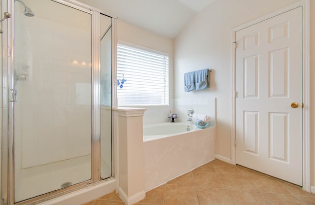 bathroom with vaulted ceiling, separate shower and tub, and tile patterned flooring