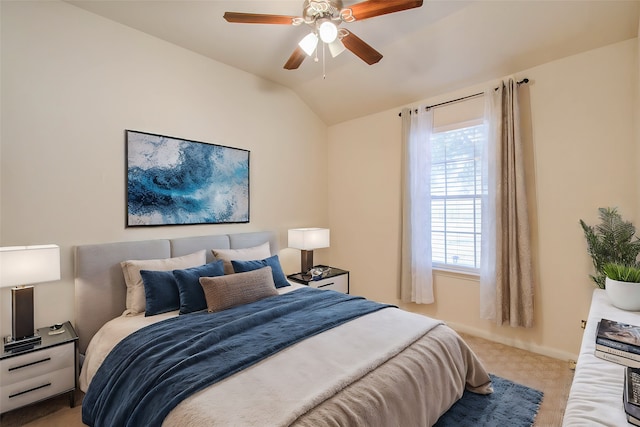 carpeted bedroom with vaulted ceiling and ceiling fan