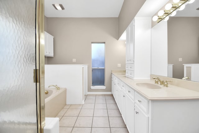 bathroom with tile patterned flooring, vanity, and a bathtub