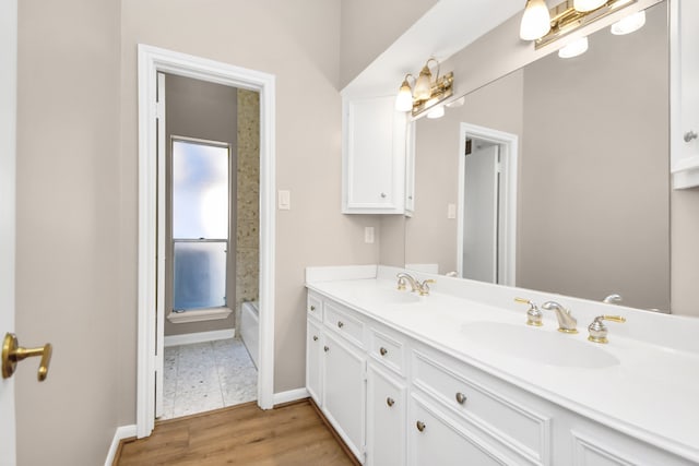 bathroom with wood-type flooring, tub / shower combination, and vanity