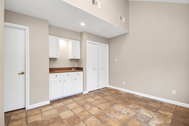 kitchen with white cabinetry and sink