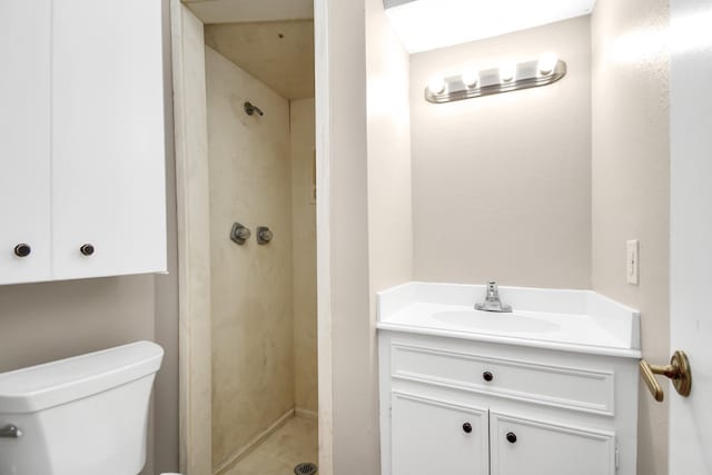 bathroom with walk in shower, vanity, and toilet