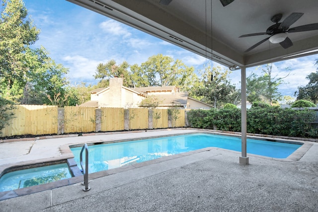 view of pool with a patio, ceiling fan, and an in ground hot tub