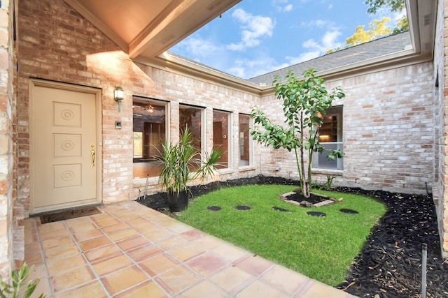 doorway to property featuring a yard