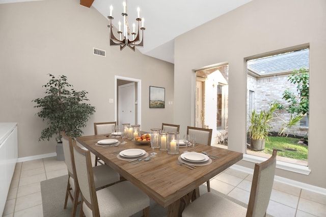 dining space with high vaulted ceiling, a notable chandelier, and light tile patterned floors