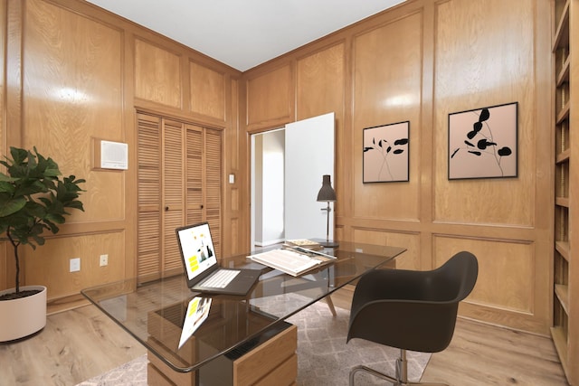 home office featuring wood walls and light hardwood / wood-style flooring