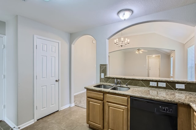 kitchen featuring black dishwasher, light stone countertops, light tile patterned floors, lofted ceiling, and sink