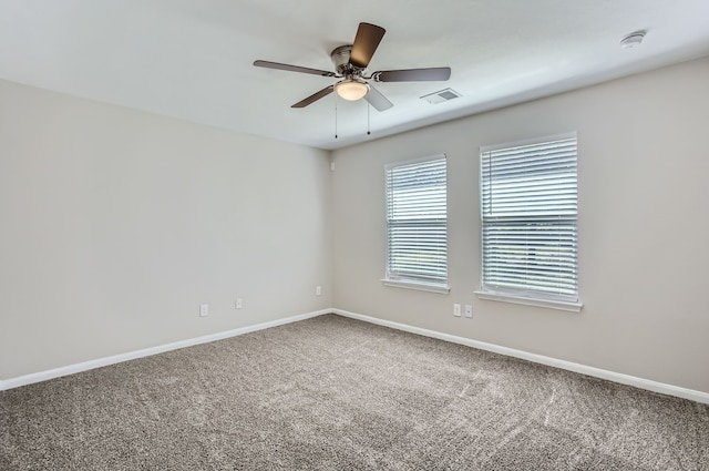 carpeted spare room with ceiling fan