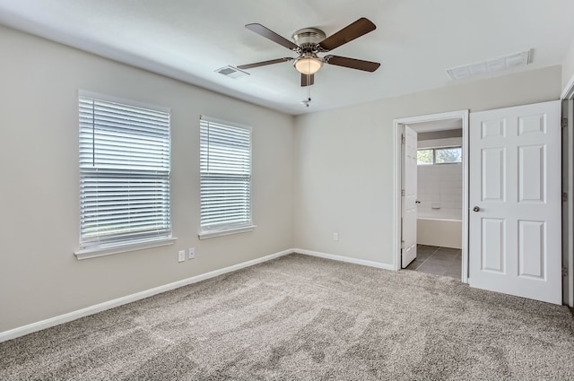 unfurnished bedroom with light carpet, ensuite bath, and ceiling fan