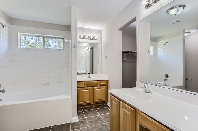 bathroom featuring tiled shower / bath, vanity, and tile patterned floors