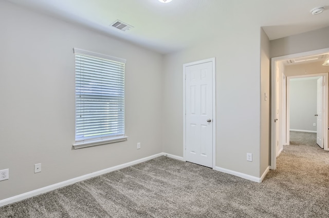 unfurnished bedroom with light colored carpet