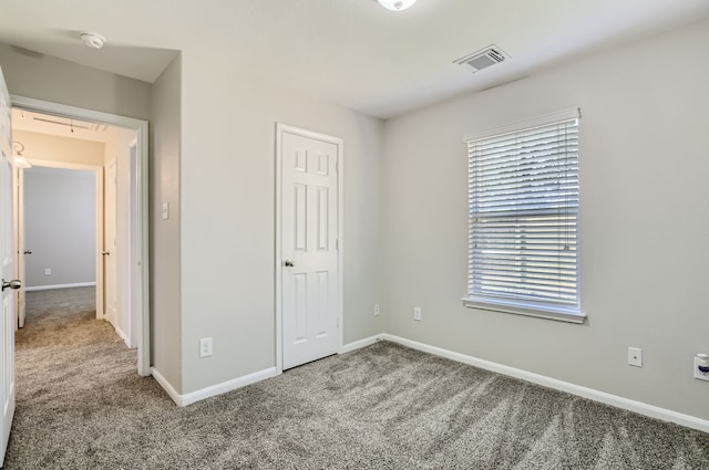 unfurnished bedroom featuring carpet and a closet