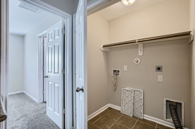 washroom featuring dark tile patterned flooring, hookup for an electric dryer, hookup for a washing machine, and gas dryer hookup