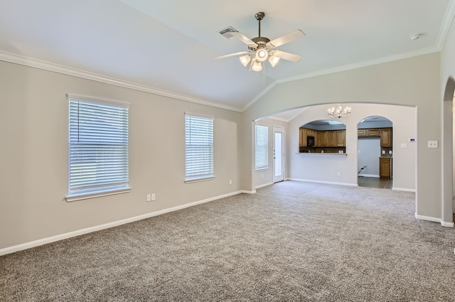 unfurnished living room featuring carpet, vaulted ceiling, ornamental molding, and plenty of natural light