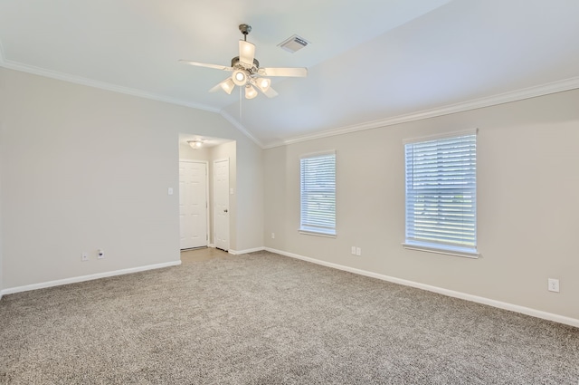 carpeted empty room featuring vaulted ceiling, ceiling fan, and crown molding