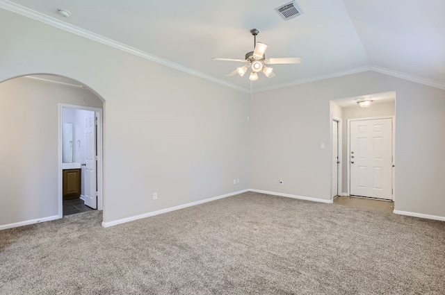 unfurnished room featuring carpet floors, ornamental molding, vaulted ceiling, and ceiling fan