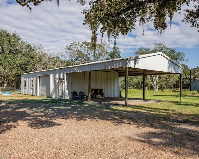 view of outbuilding with a lawn and a carport