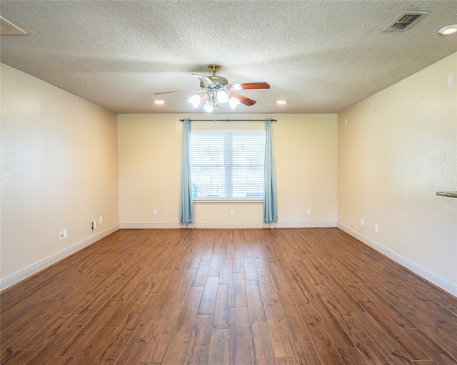 unfurnished room with a textured ceiling, ceiling fan, and dark wood-type flooring