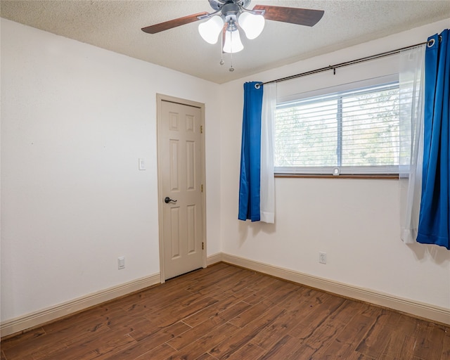 empty room featuring a textured ceiling, wood-type flooring, and ceiling fan