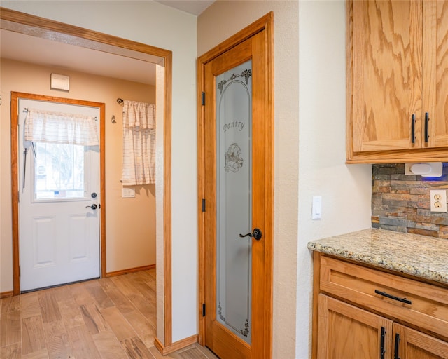 interior space featuring light stone countertops and light hardwood / wood-style floors