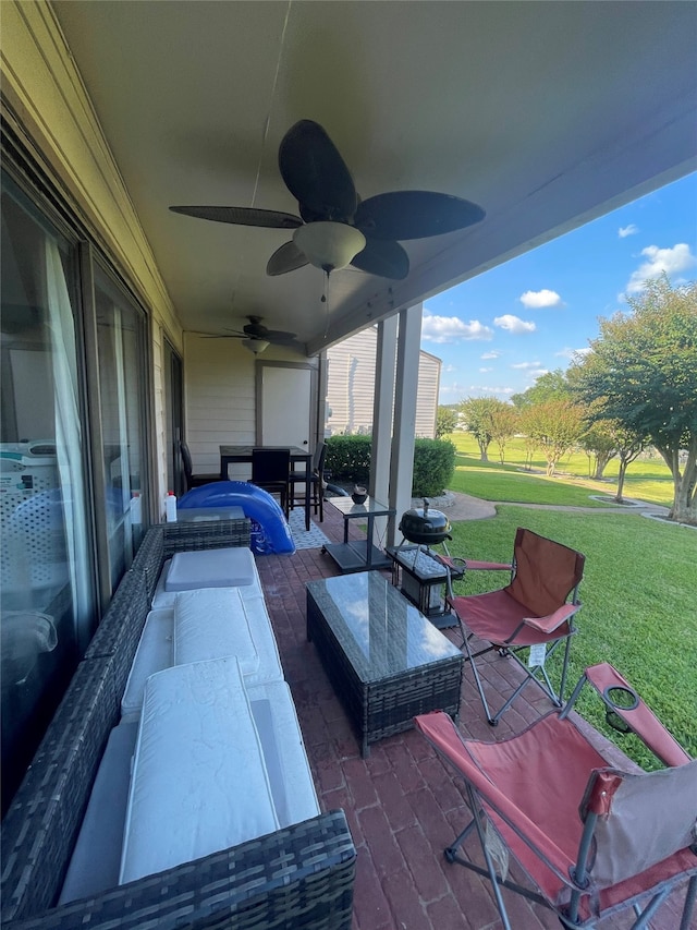 view of patio with an outdoor living space and ceiling fan