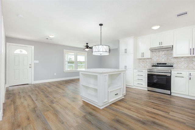 kitchen featuring white cabinets, hanging light fixtures, light hardwood / wood-style flooring, and stainless steel electric range oven